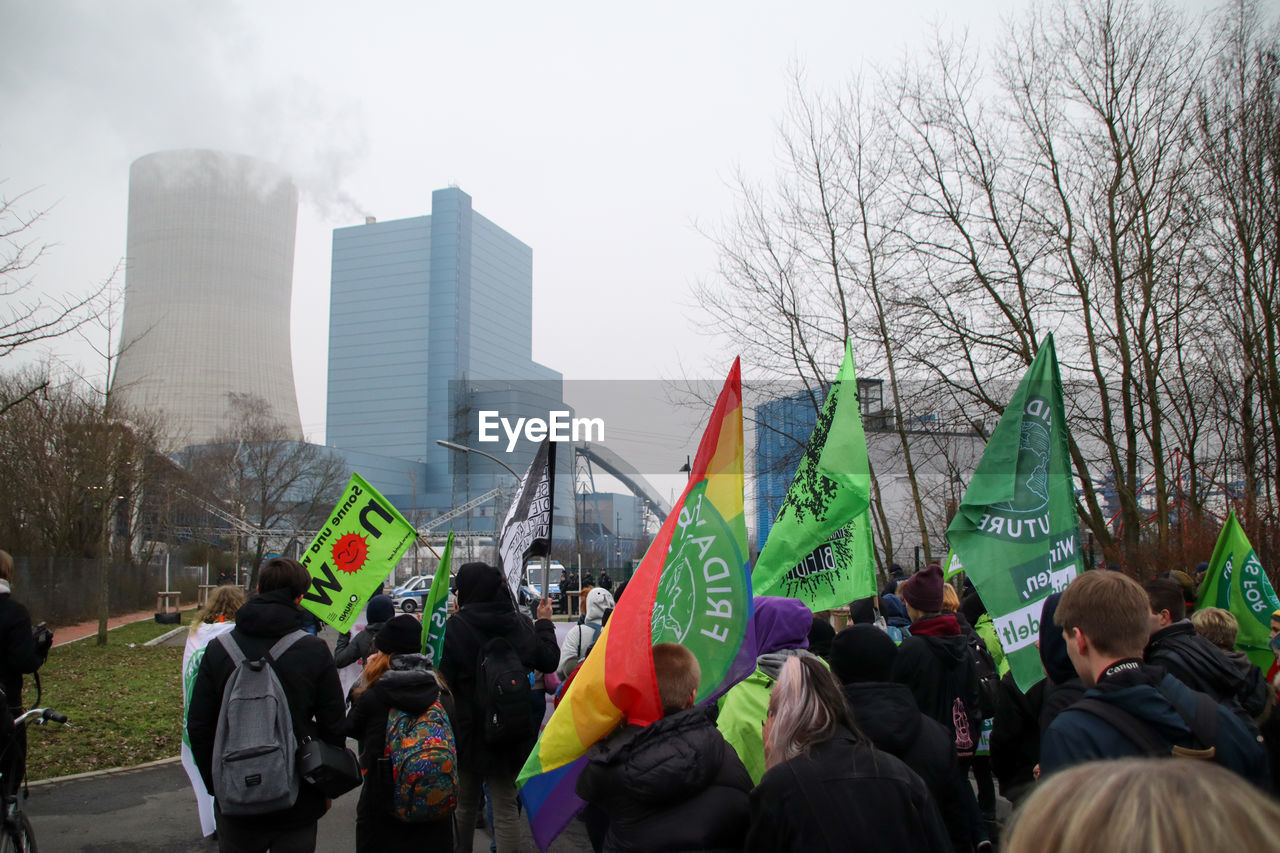 GROUP OF PEOPLE AGAINST BUILT STRUCTURES