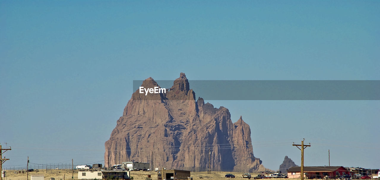 Ship rock against clear sky