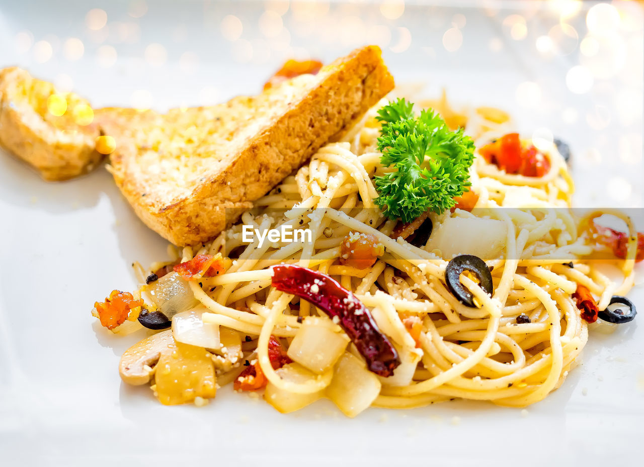 Delicious spaghetti with bacon and bread- italian food style.