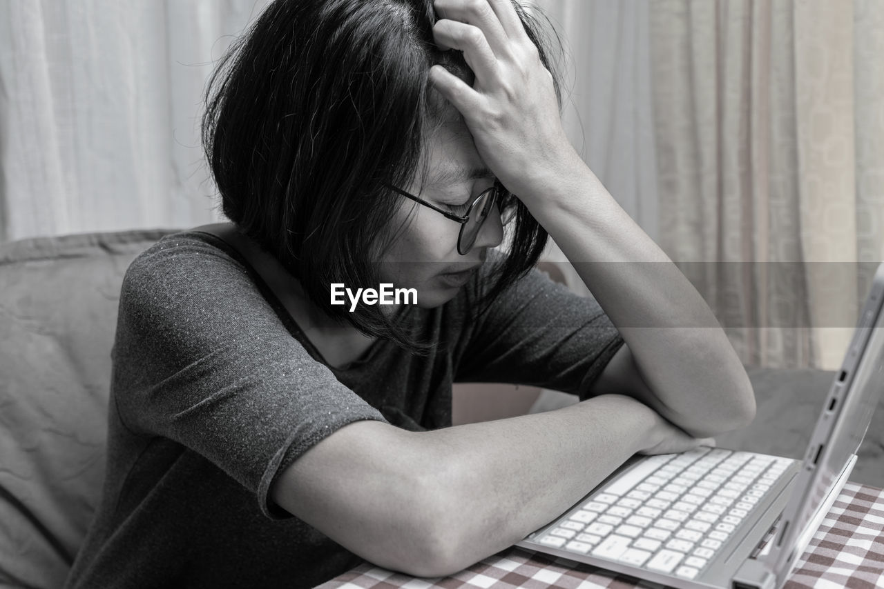 Exhausted businesswoman for work at home. gray photo concept