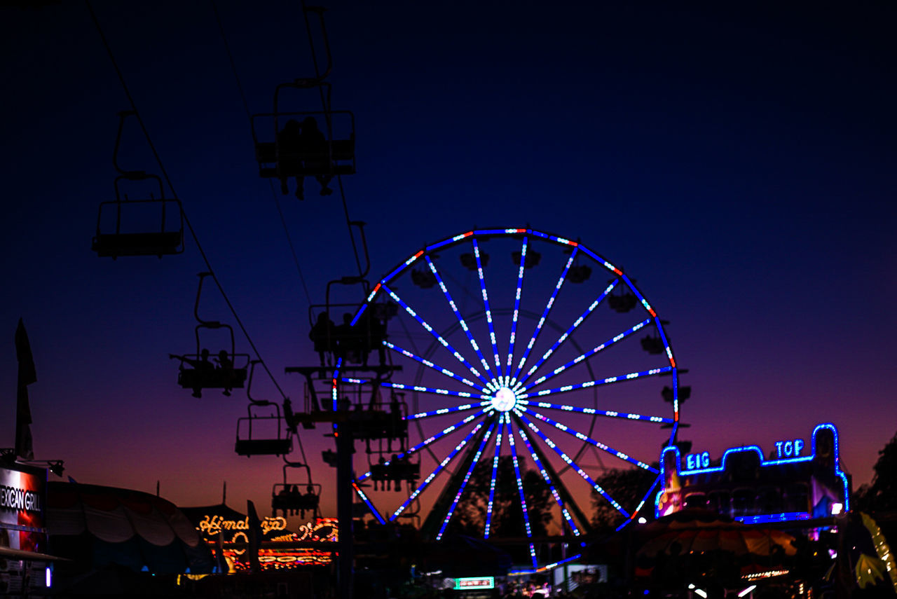 LOW ANGLE VIEW OF ILLUMINATED FERRIS WHEEL AT NIGHT