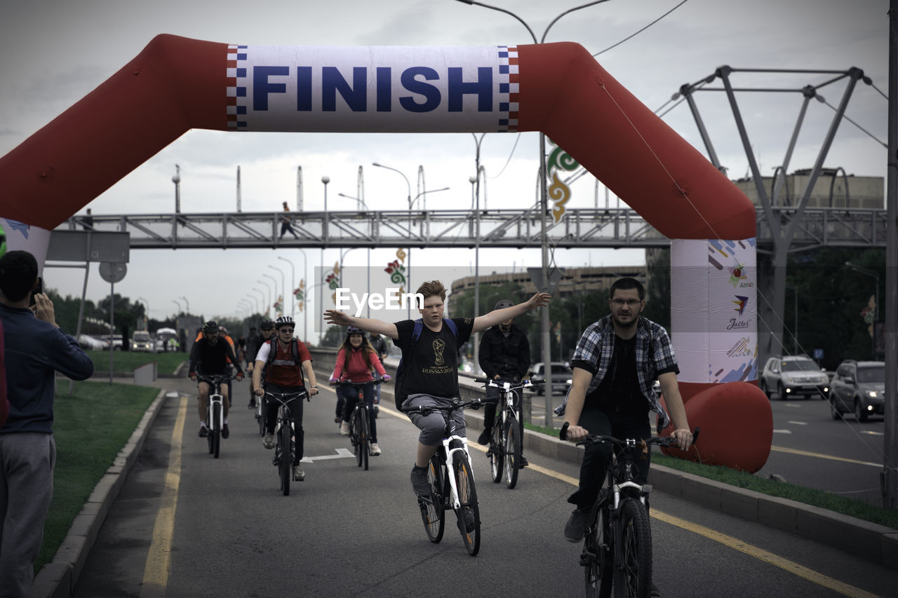 PEOPLE RIDING BICYCLES ON ROAD