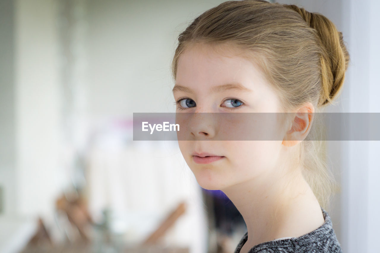 Close-up portrait of girl at home