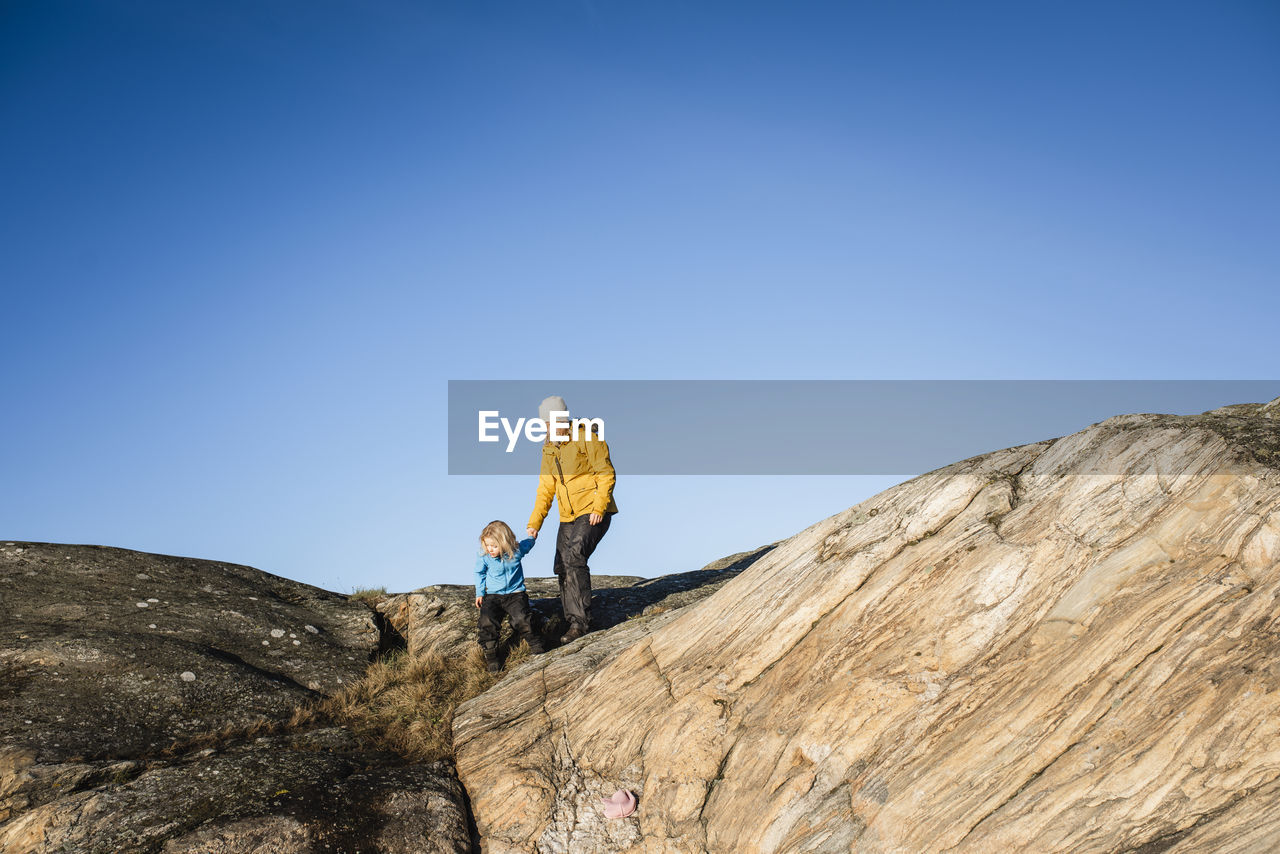 Woman and girl on rocks