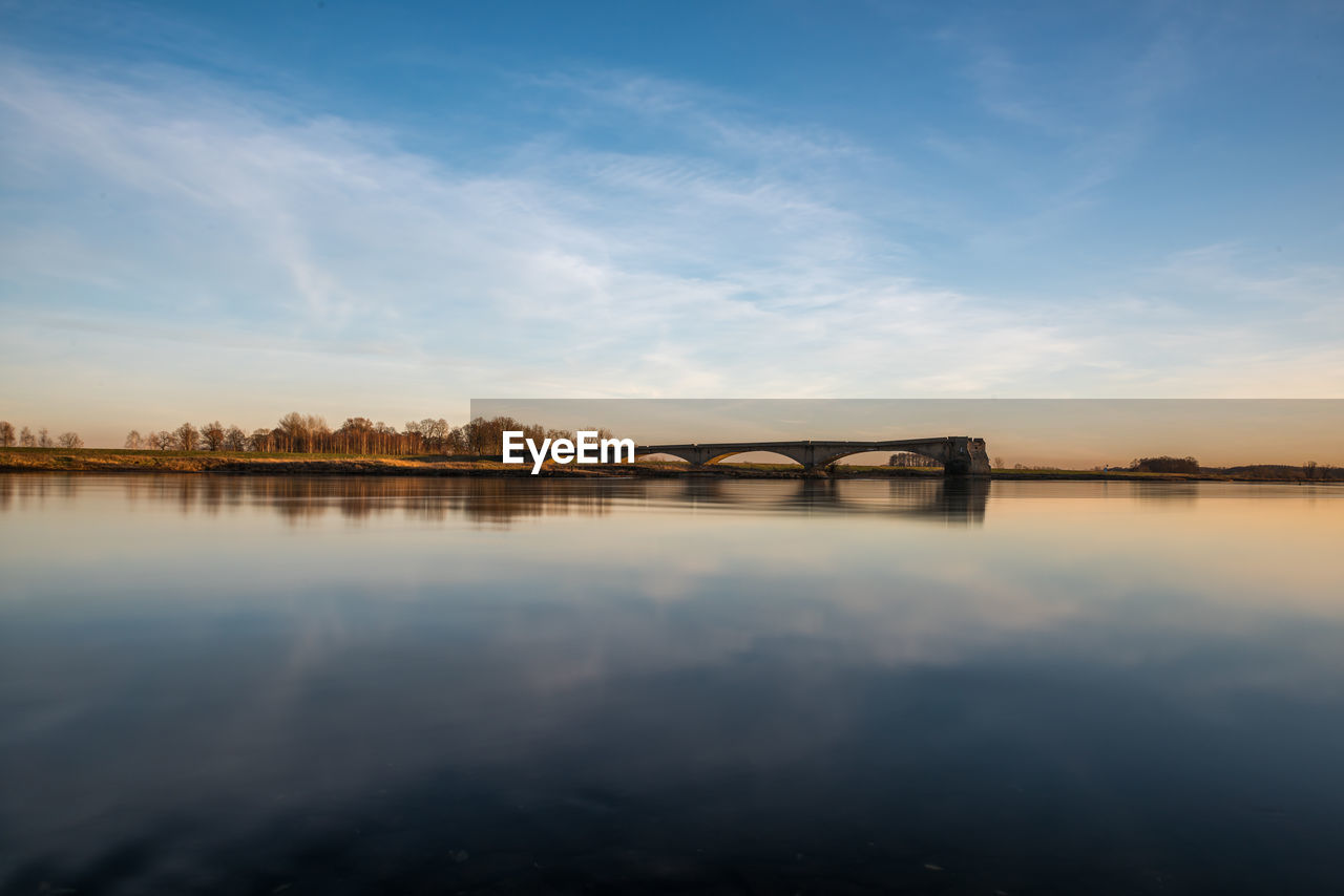 Scenic view of lake against sky during sunset