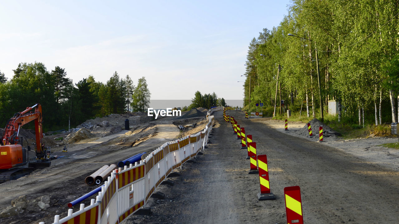 PANORAMIC VIEW OF ROAD BY TREES AGAINST SKY