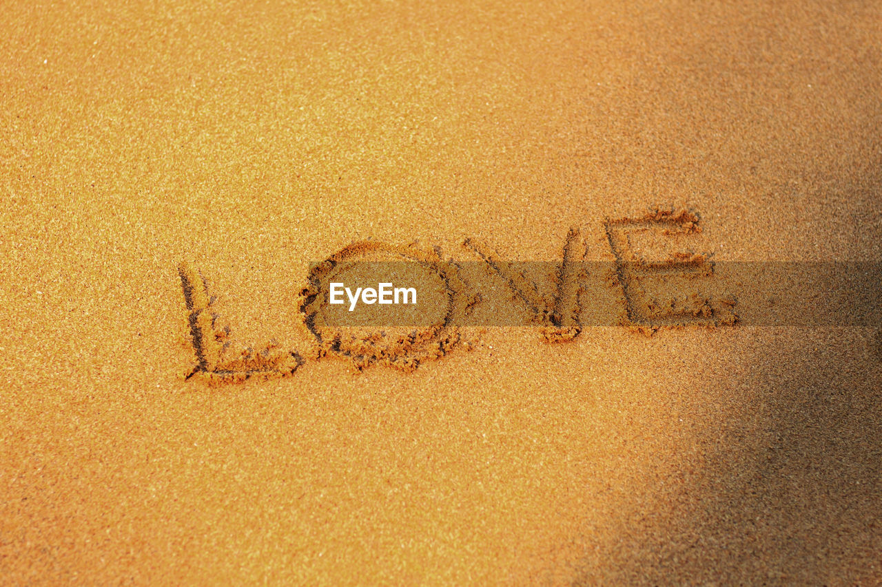 text, sand, beach, communication, western script, land, handwriting, no people, positive emotion, font, message, emotion, high angle view, nature, circle