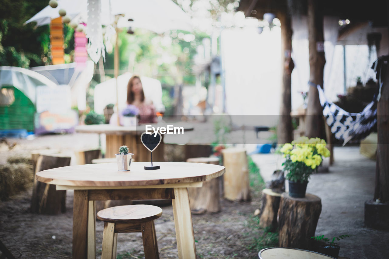 EMPTY CHAIRS AND TABLE AT CAFE