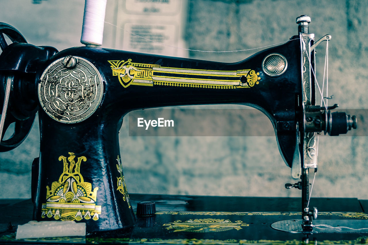 Close-up of sewing machine in room