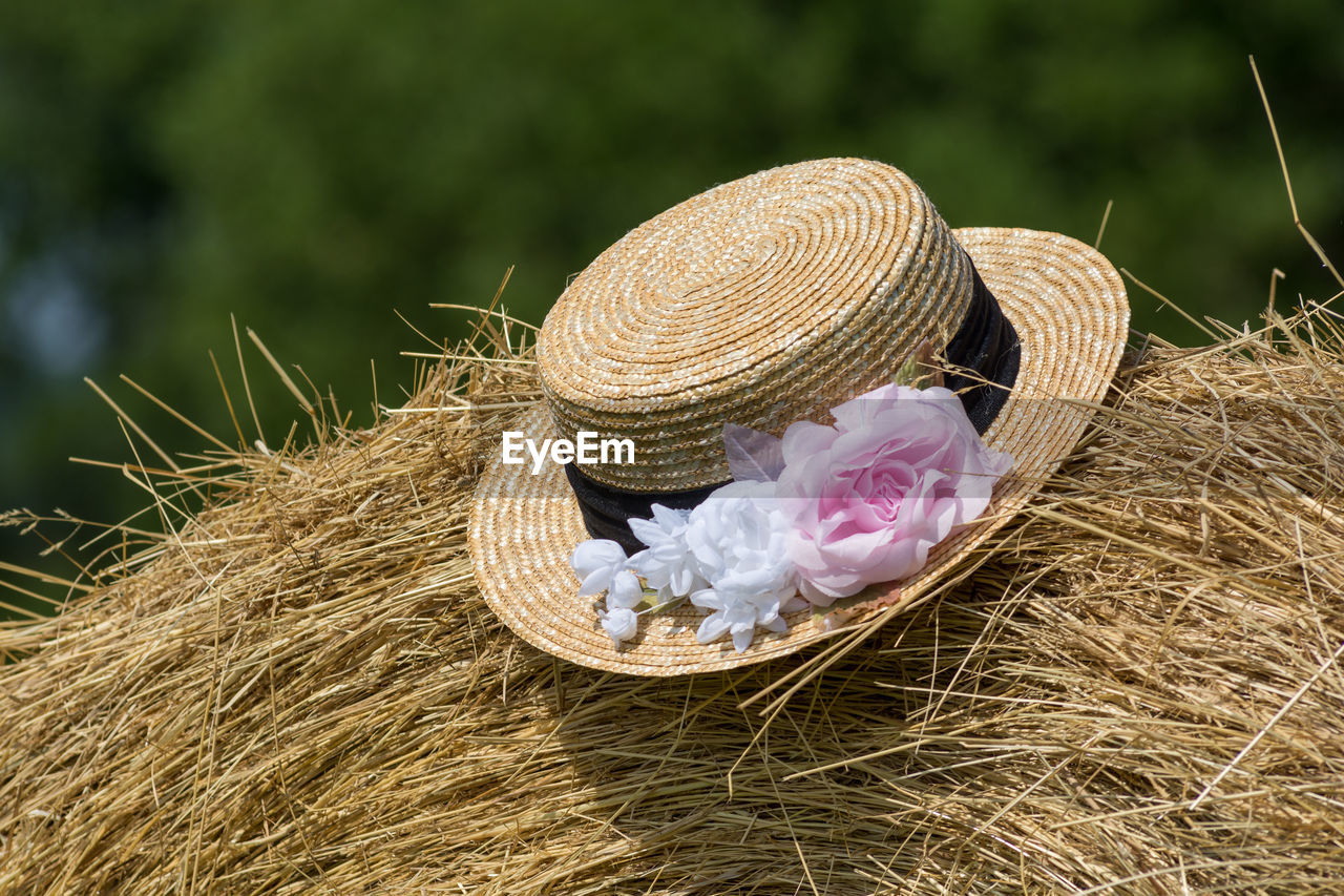 Close-up of hat on hay bales
