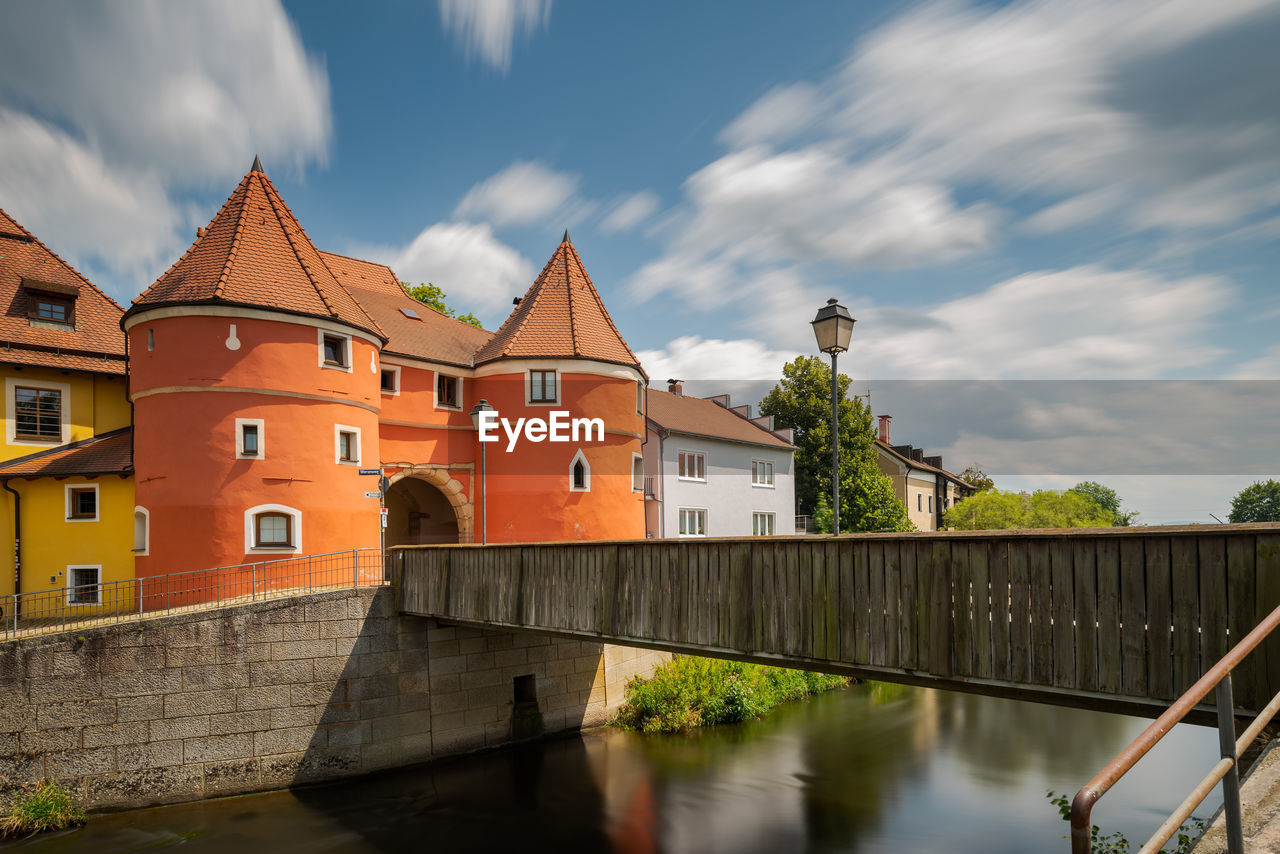 BRIDGE OVER RIVER AGAINST BUILDINGS