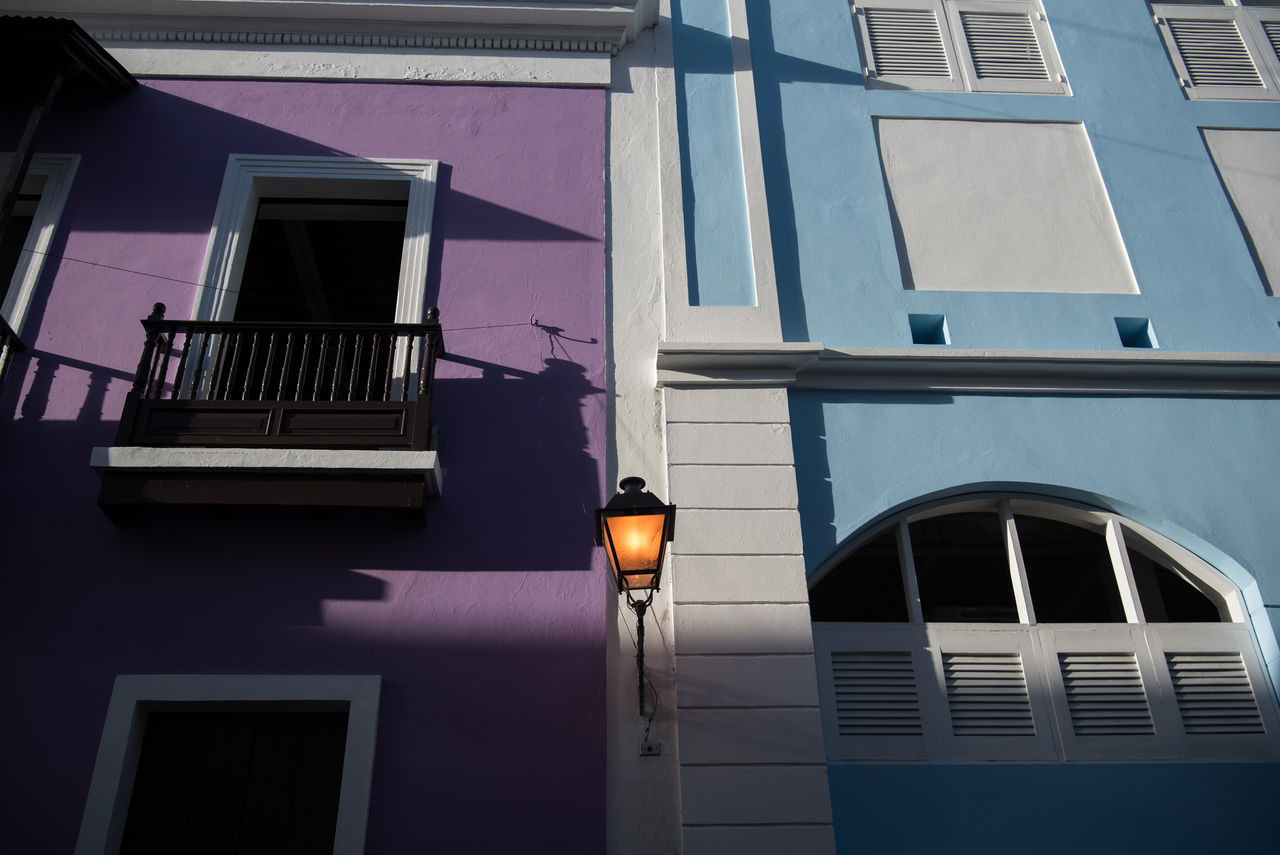 LOW ANGLE VIEW OF ILLUMINATED STREET LIGHT ON BUILDING