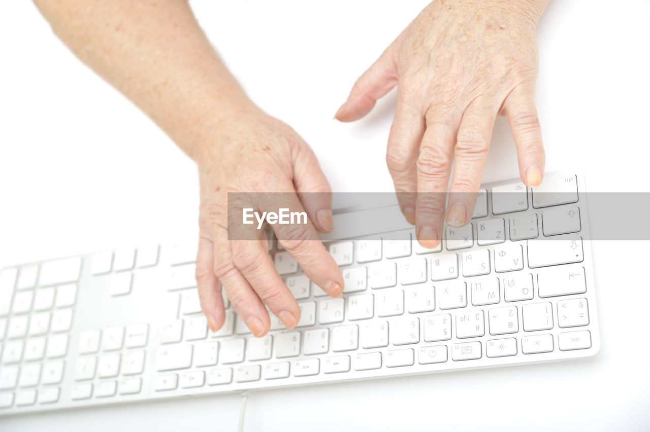 Cropped image of person typing on computer keyboard