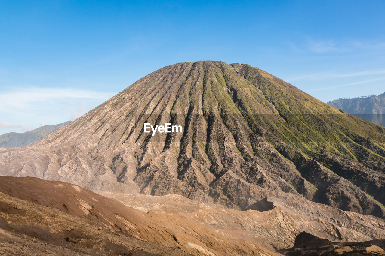 Scenic view of volcanic mountain against sky