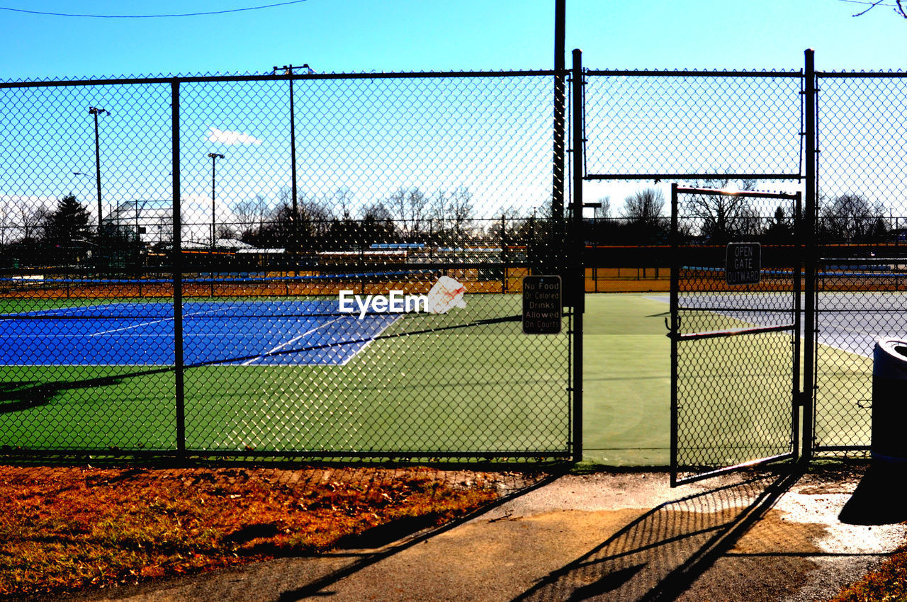 Tennis court seen through fence