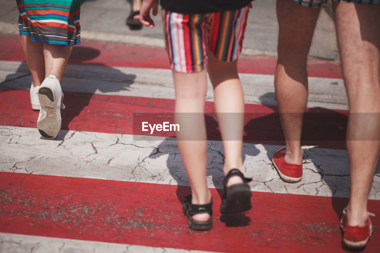 Low section of people walking on road