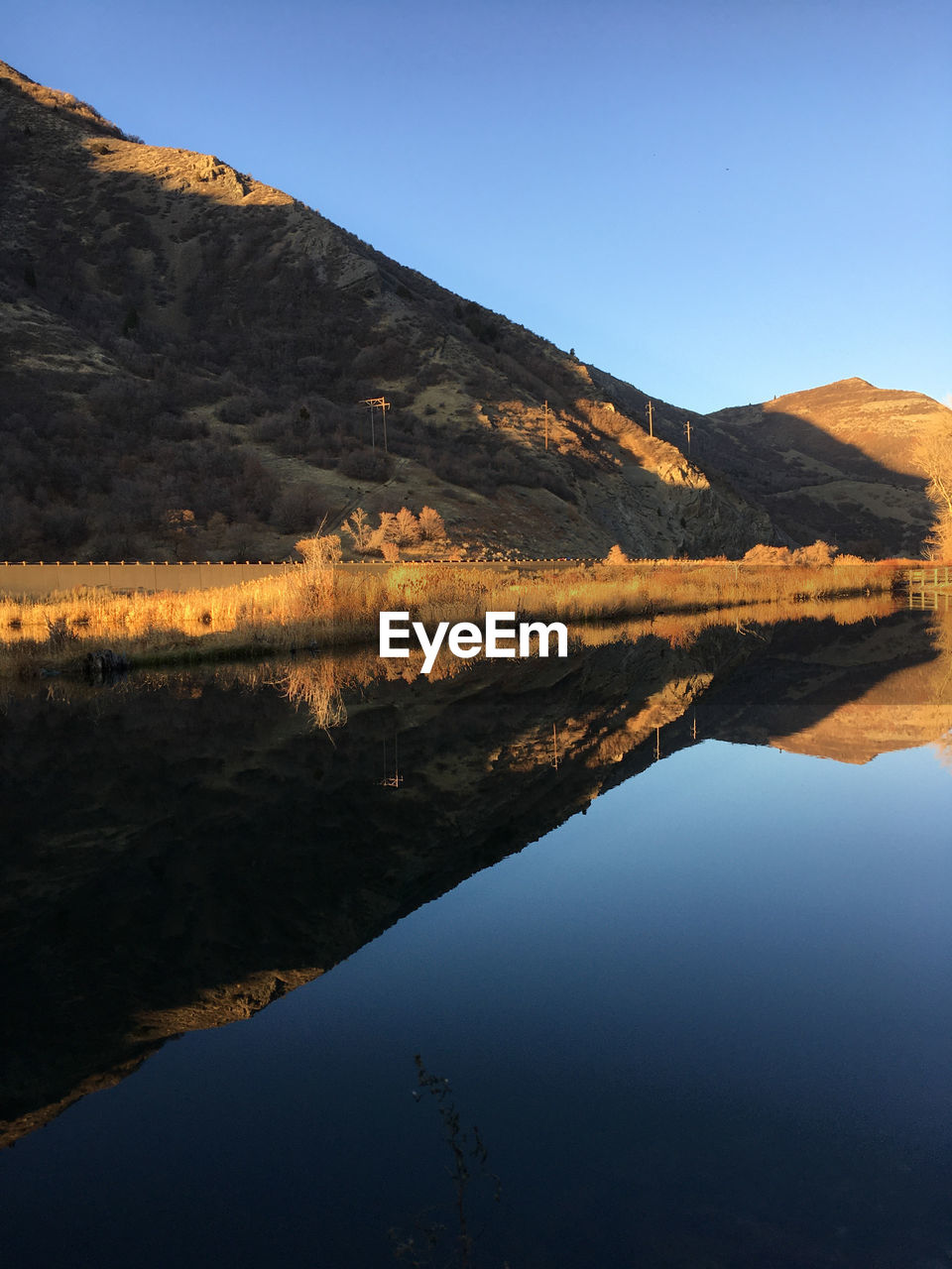 Scenic view of lake and mountains against clear sky