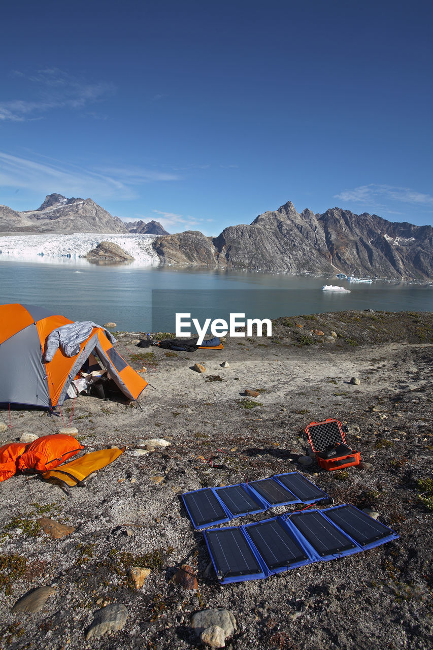 Solar panels charging batteries at camping spot in eastern greenland