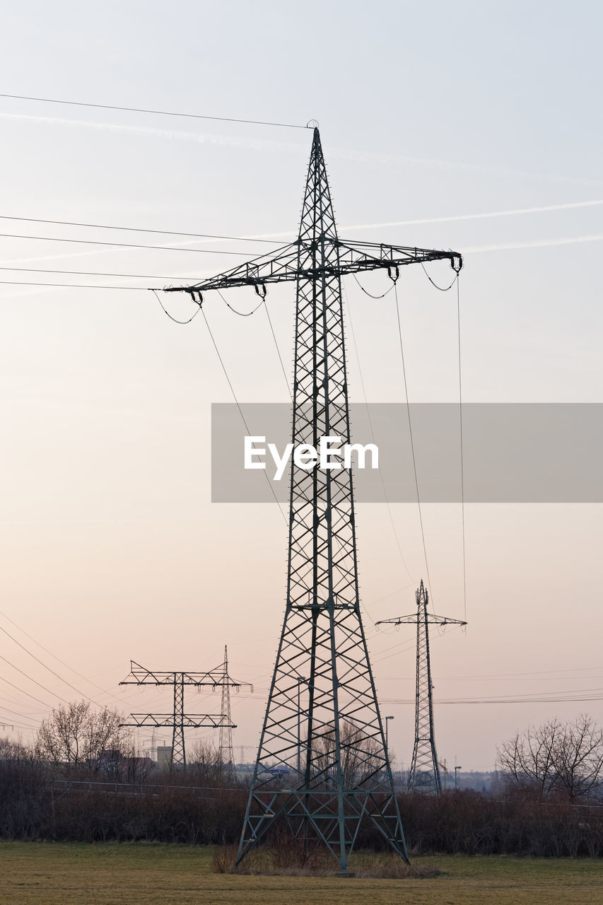 Several large electricity pylons in different types with cables