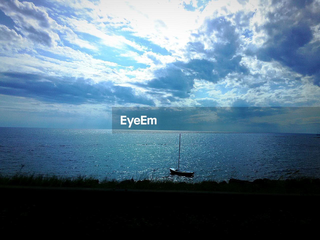 Scenic view of sea against cloudy sky