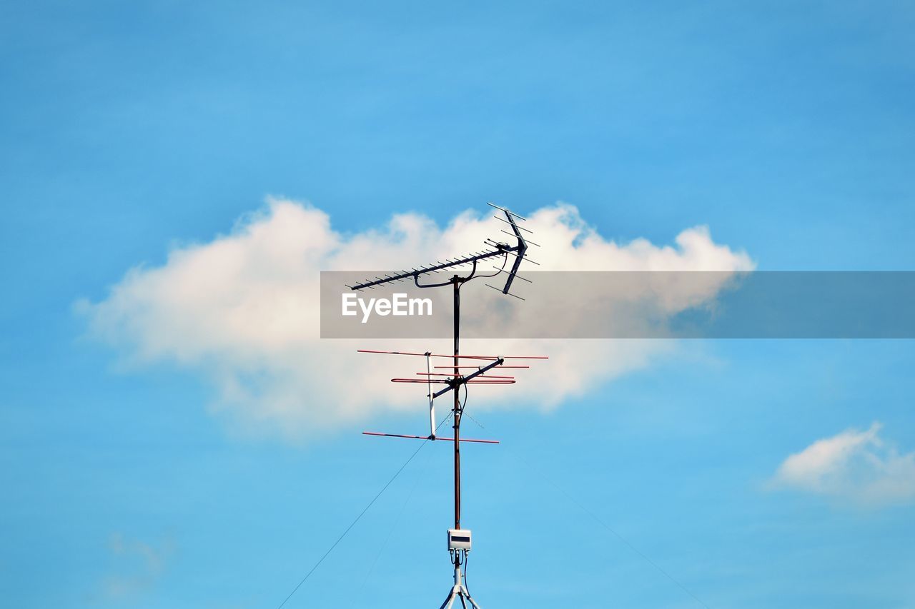 low angle view of airplane flying against sky