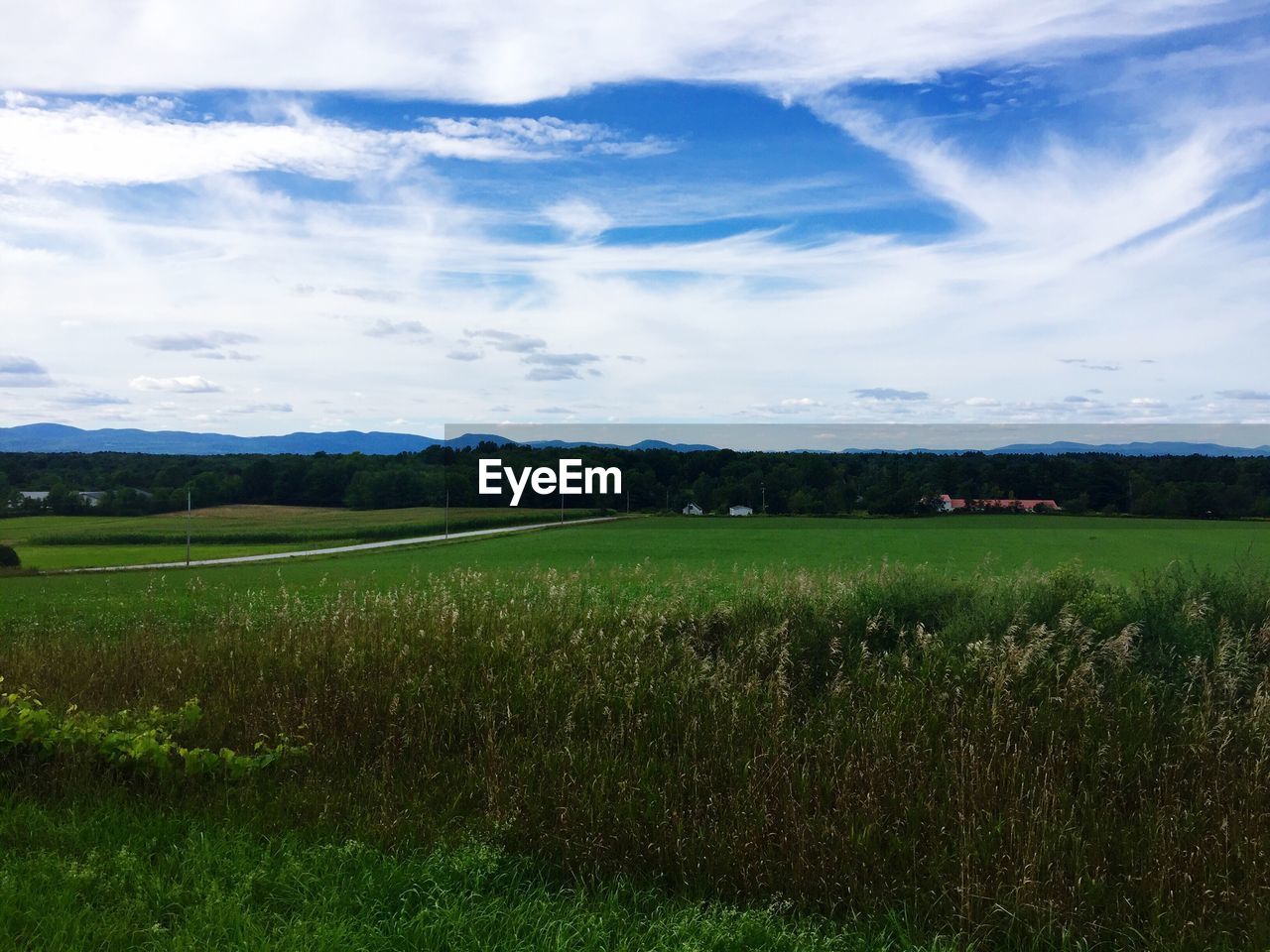 Scenic view of landscape against cloudy sky