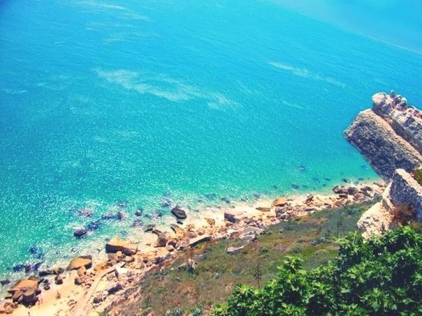 SCENIC VIEW OF SEA WITH ROCKS IN BACKGROUND