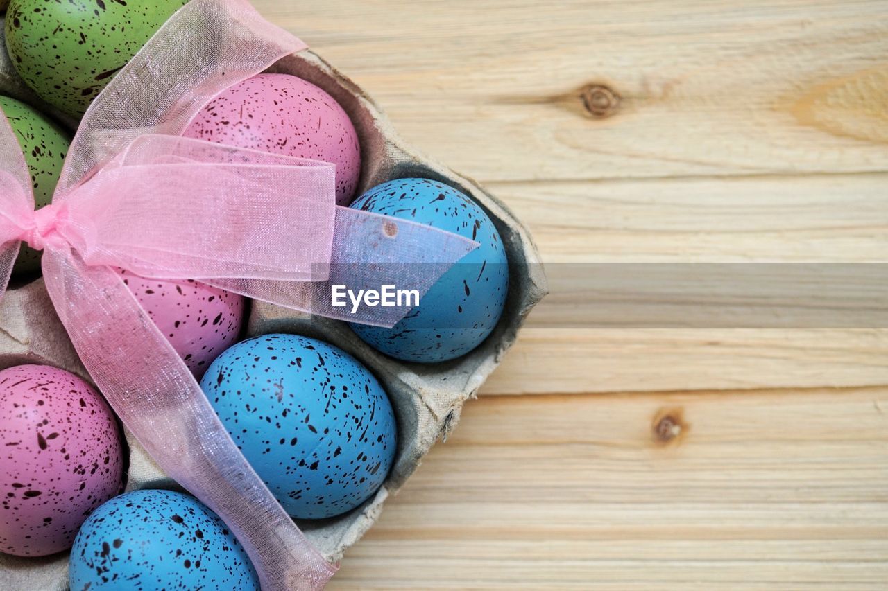 High angle view of multi colored eggs on table