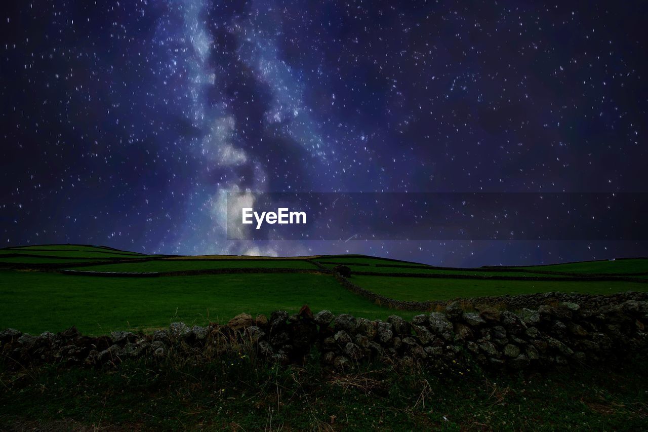 Scenic view of landscape against star field