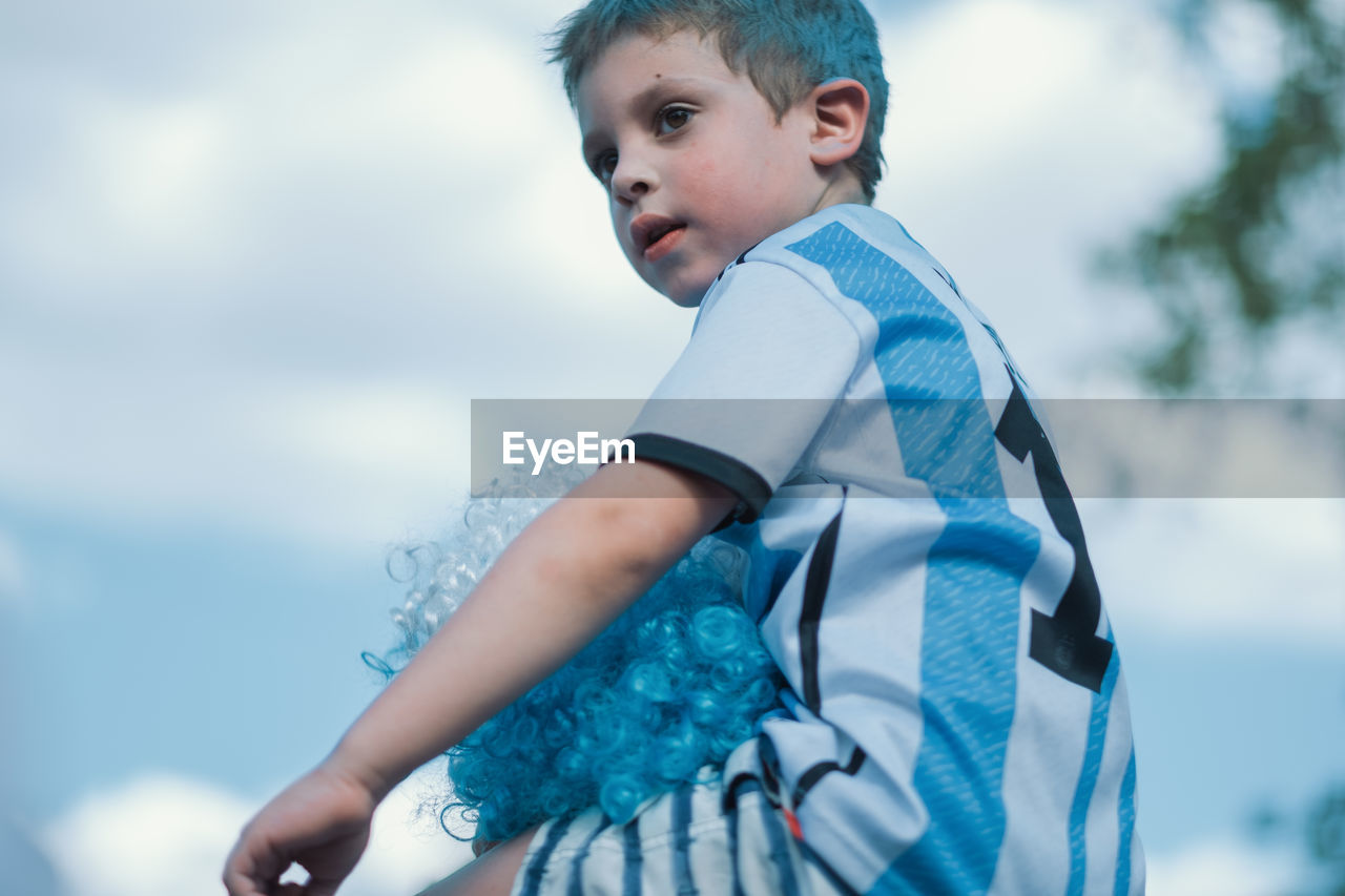 Low angle portrait of argentinian child celebrating victory on fifa world cup 2022 qatar