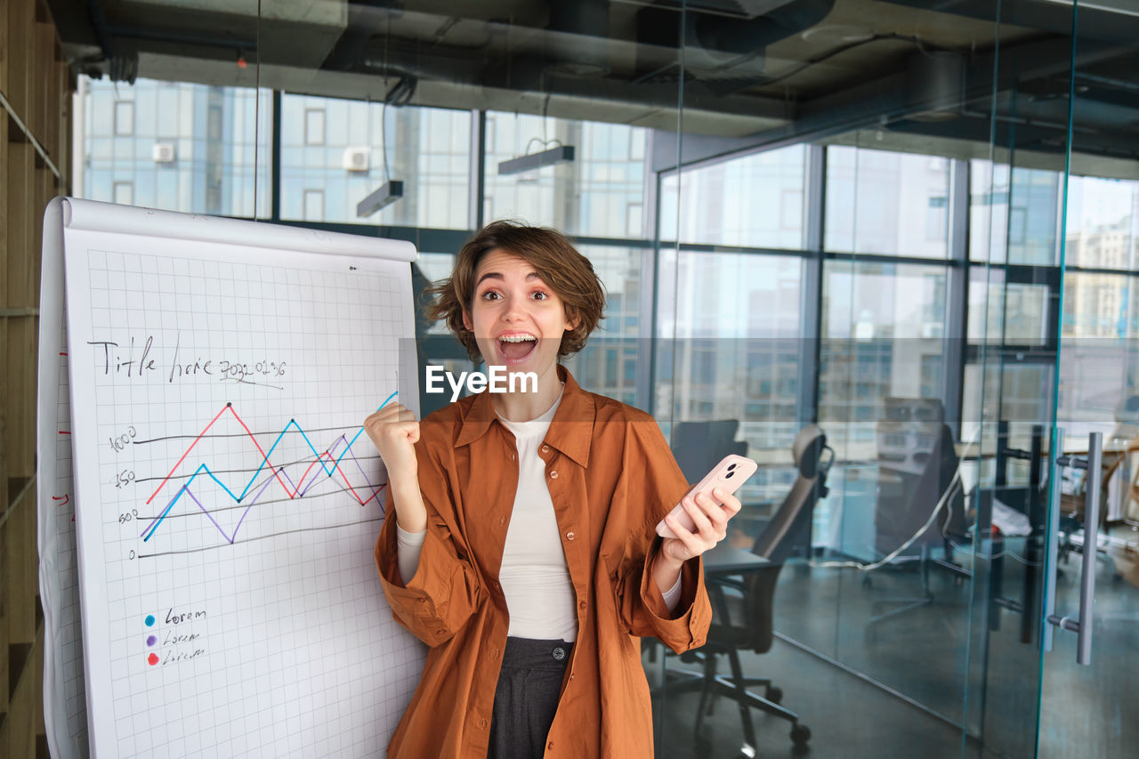 portrait of young businesswoman standing in city