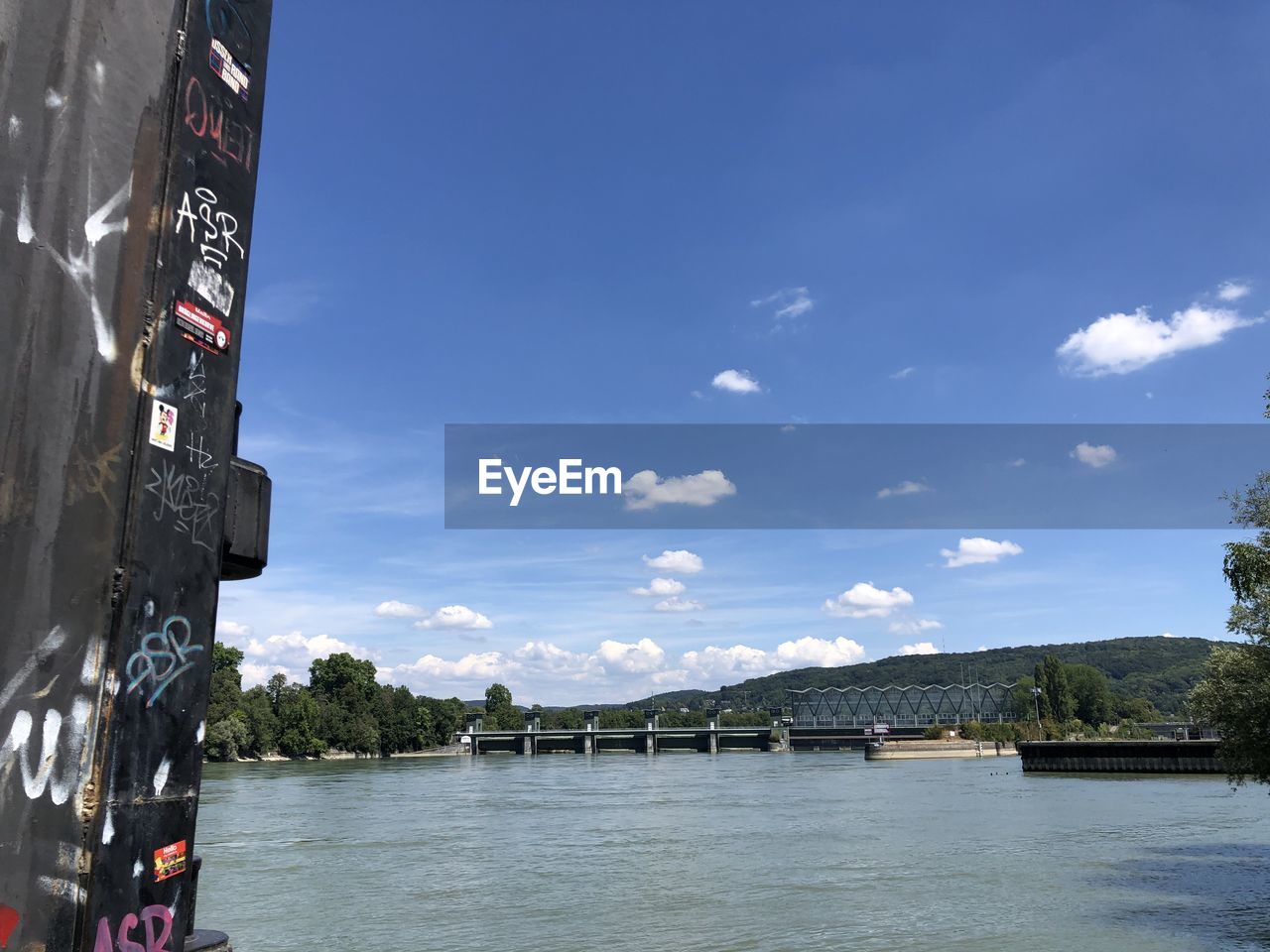 BRIDGE BY RIVER AGAINST SKY