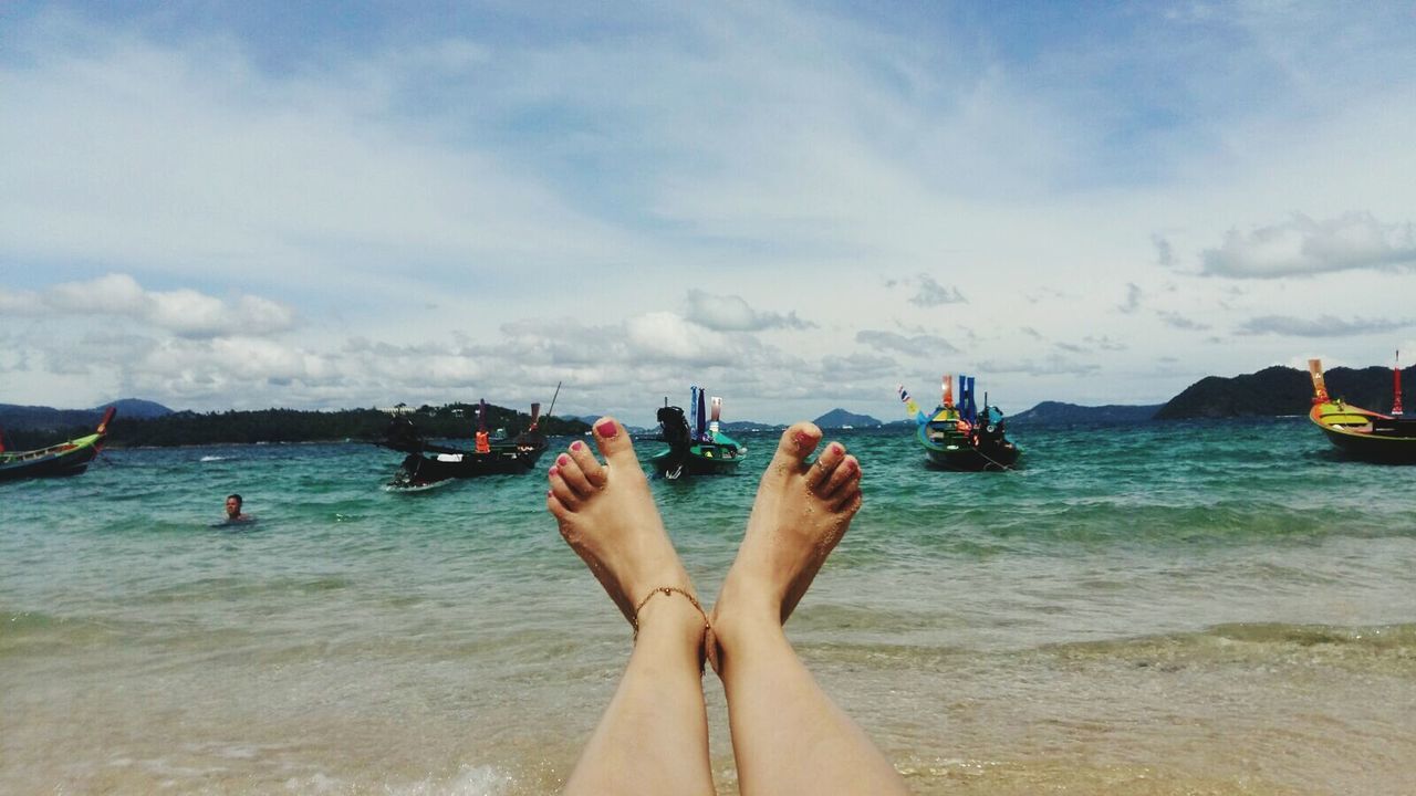 Low section of woman relaxing on beach