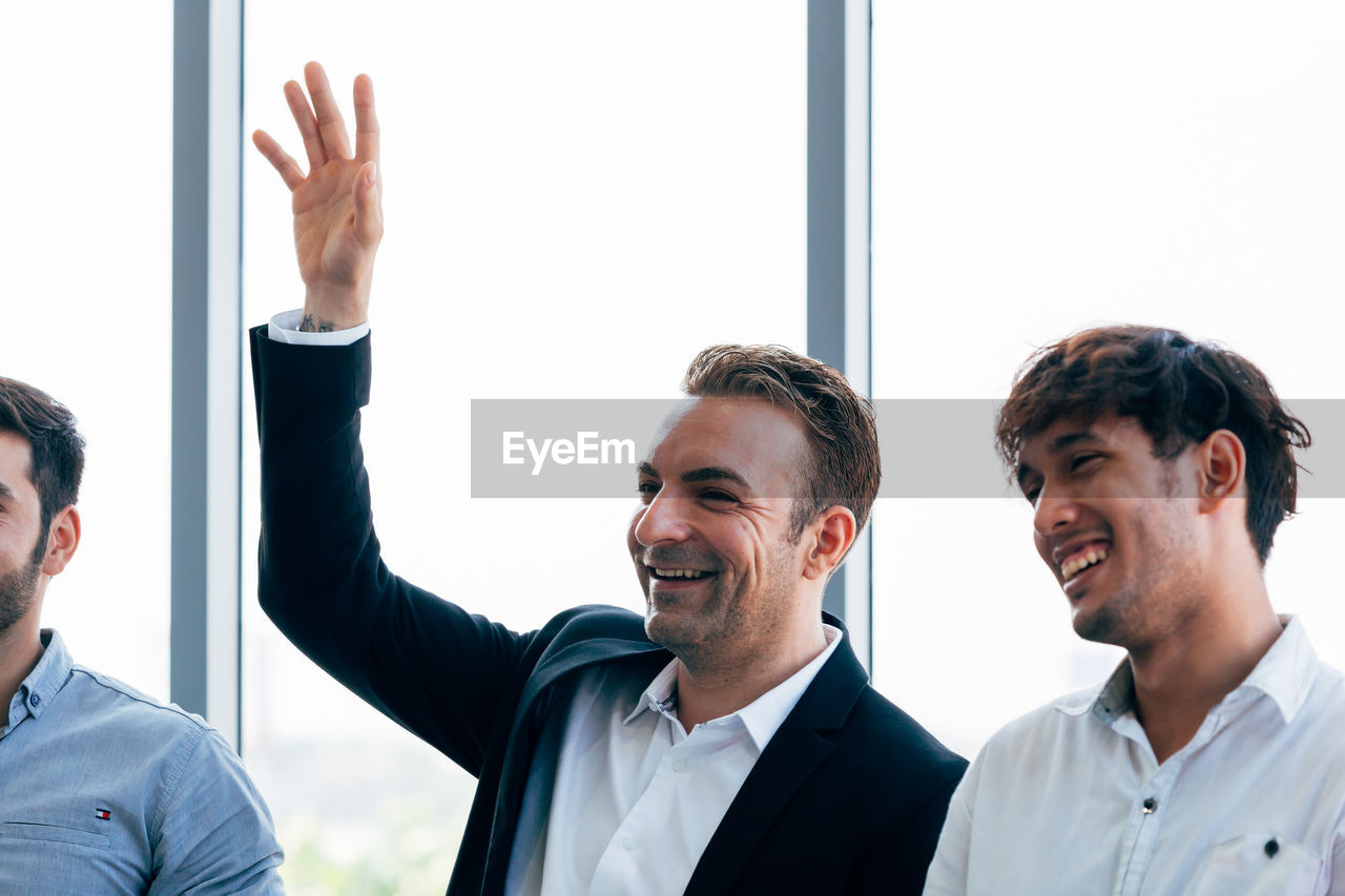 Smiling business colleagues sitting at office