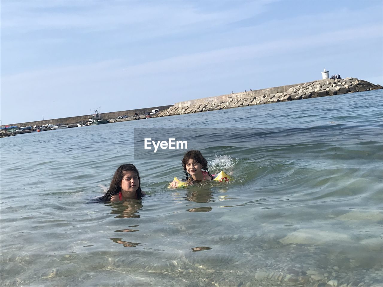 PORTRAIT OF WOMEN SWIMMING IN SEA