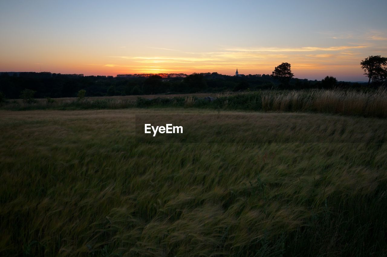 SCENIC VIEW OF LANDSCAPE AGAINST SKY DURING SUNSET