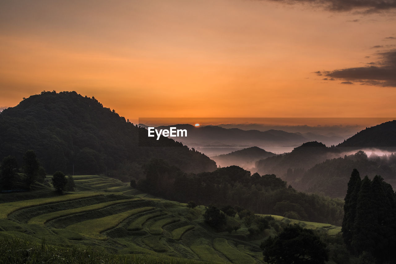 Scenic view of mountains against sky during sunset