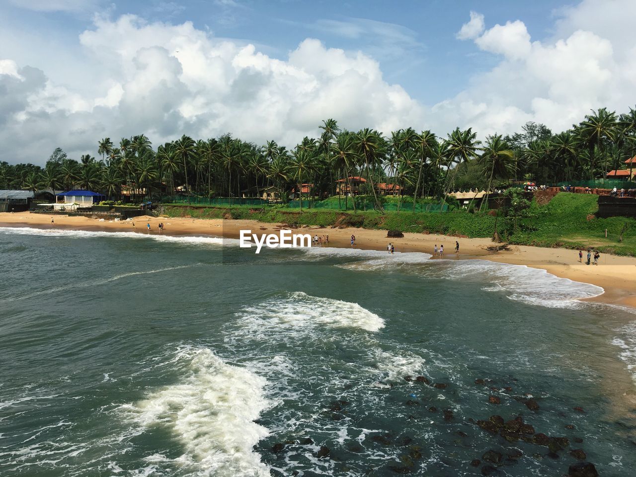 Scenic view of tourists on beach