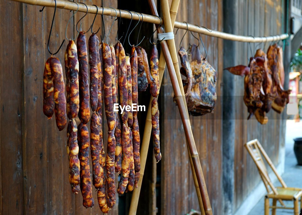 Close-up of meat hanging on barbecue grill