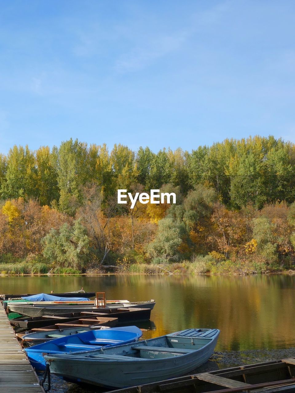 BOAT MOORED BY LAKE AGAINST SKY