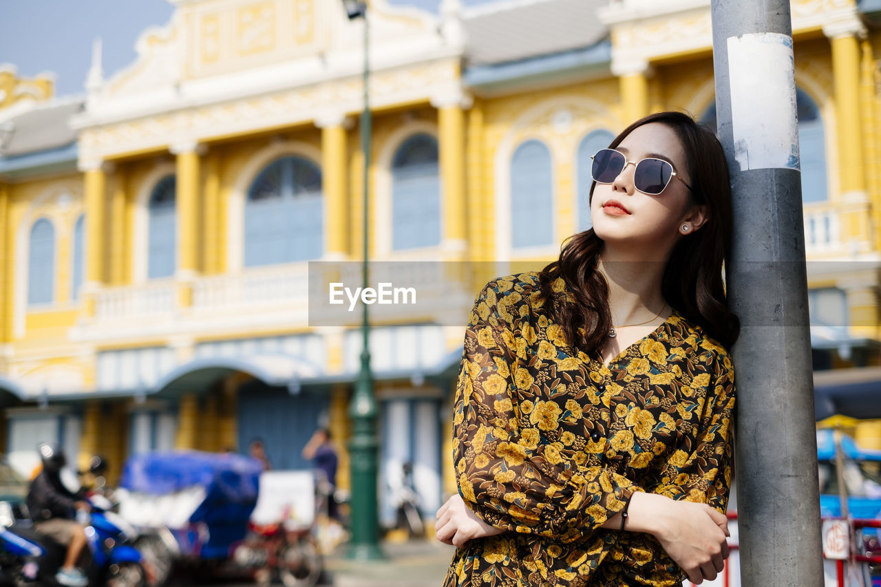 Woman wearing sunglasses standing outdoors