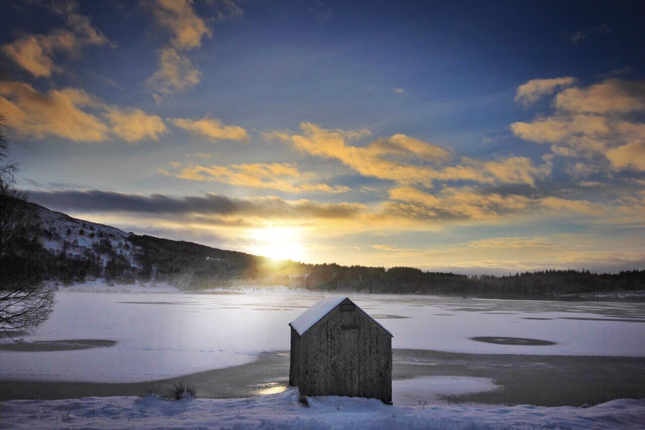 Scenic view of snowy landscape against sky during sunset