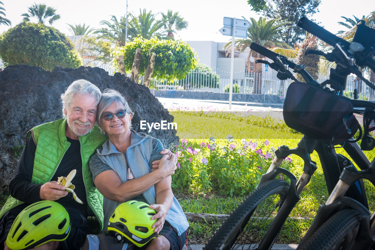 Portrait of happy couple siting at park