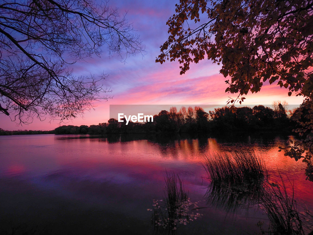 Scenic view of lake against sky during sunset