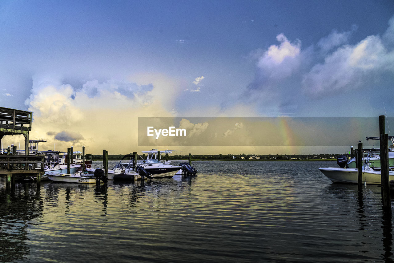 VIEW OF BOATS IN MARINA AT SUNSET