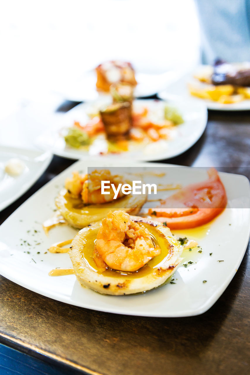 High angle view of food served in plates on table