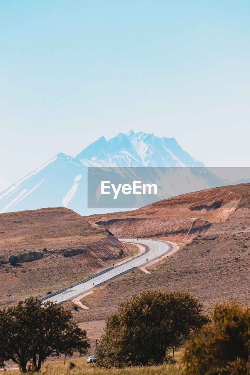 Scenic view of mountains against clear blue sky