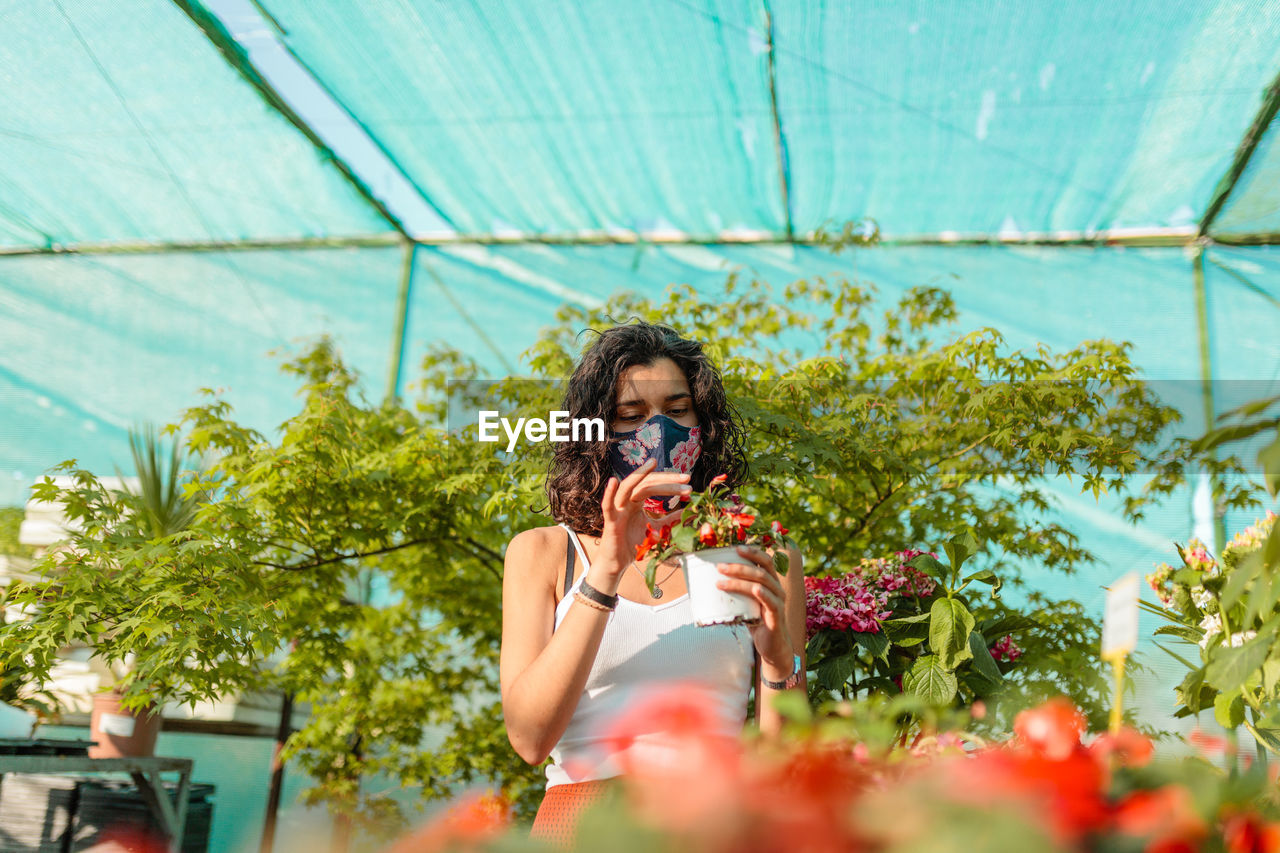 Woman looking at flowering plants