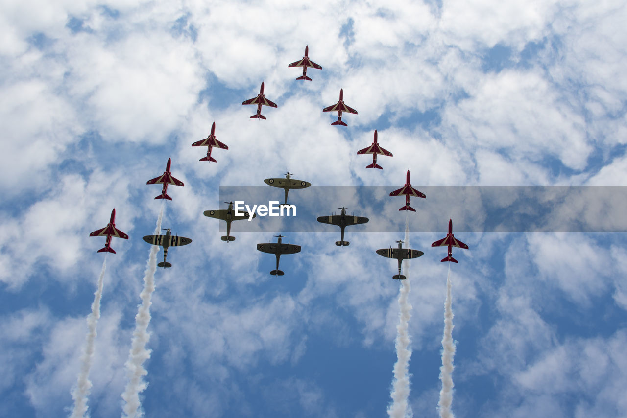 Low angle view of airshow against sky