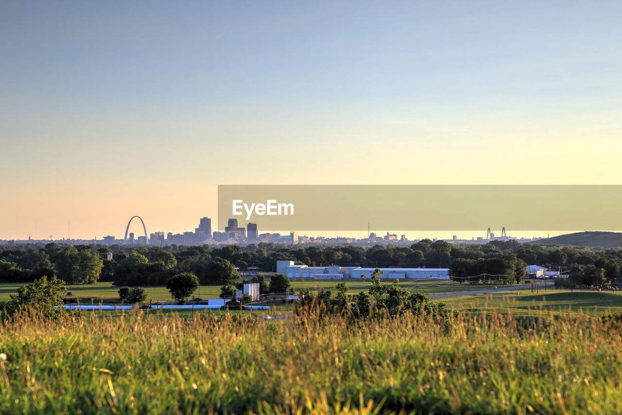 Scenic view of field against clear sky during sunset